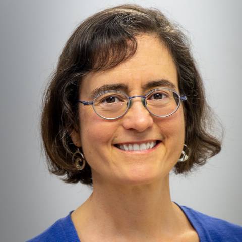 woman with short brown hair and glasses